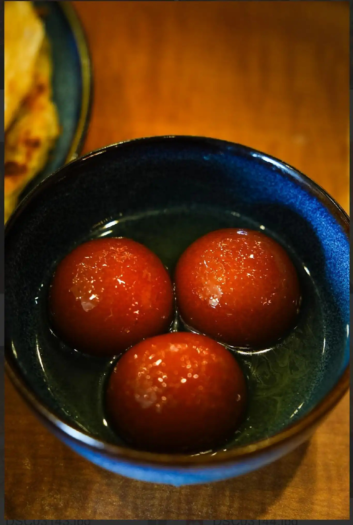 Gulab Jamun - Soft milk dumplings soaked in fragrant rose and cardamom syrup